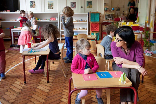 A child learning to count with wooden blocks.